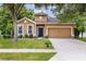 Charming single-Gathering home with a well-manicured lawn, beautiful trees, and a welcoming front door at 805 Gordonia Ct, Deland, FL 32724