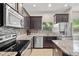 Modern kitchen with stainless steel appliances and granite countertops at 805 Gordonia Ct, Deland, FL 32724