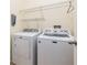 Laundry room including a washer and dryer with shelving above for organized storage at 805 Gordonia Ct, Deland, FL 32724