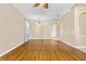 Large living room showcasing hardwood floors, modern light fixtures, and neutral paint at 805 Gordonia Ct, Deland, FL 32724
