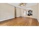 Open-concept living room with wood floors and kitchen access at 805 Gordonia Ct, Deland, FL 32724