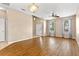 Spacious living room with hardwood floors, bright windows, and modern lighting fixtures at 805 Gordonia Ct, Deland, FL 32724