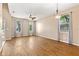 Living room featuring hardwood floors, bright windows with sheer curtains, a ceiling fan, and modern lighting at 805 Gordonia Ct, Deland, FL 32724