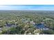 Breathtaking aerial view of houses bordering a calm lake with lush green trees surrounding it at 8121 Via Bonita, Sanford, FL 32771