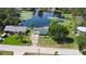 Aerial view of a light blue single-story home with an attached garage located on a freshwater canal at 8121 Via Bonita, Sanford, FL 32771