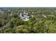 Aerial view of single-story home with a freshwater canal surrounded by lush greenery at 8121 Via Bonita, Sanford, FL 32771