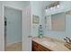 Well-lit bathroom vanity area with a modern sink, decorative lighthouse, and open doorway at 8121 Via Bonita, Sanford, FL 32771
