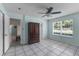 Bedroom with ceiling fan, closet, tile flooring, and window view with natural light at 8121 Via Bonita, Sanford, FL 32771
