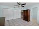 Bedroom with ceiling fan, tile floors, closet, and window with natural light at 8121 Via Bonita, Sanford, FL 32771