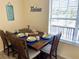 Cozy dining room with wood-look floors and a table set for four near a large window at 8121 Via Bonita, Sanford, FL 32771