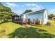 Charming home exterior featuring a deck, porch, and well-maintained lawn at 8121 Via Bonita, Sanford, FL 32771
