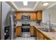 Bright kitchen featuring stainless steel appliances, light wood cabinets, and a tiled backsplash at 8121 Via Bonita, Sanford, FL 32771