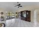 Bright living room features tile flooring, a ceiling fan, and sliding doors to a deck overlooking the water at 8121 Via Bonita, Sanford, FL 32771