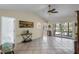 Bright living room features tile flooring, a ceiling fan, and sliding doors to a deck overlooking the water at 8121 Via Bonita, Sanford, FL 32771