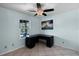 Bright office space with large window and a modern black desk, illuminated by a ceiling fan at 8121 Via Bonita, Sanford, FL 32771