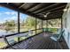 Relaxing screened porch offering scenic lake views and comfortable seating arrangements at 8121 Via Bonita, Sanford, FL 32771