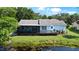Back exterior featuring screened in patio with access to the canal at 8121 Via Bonita, Sanford, FL 32771