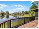 Beautiful lake view from a wooden deck, showcasing calm waters, lily pads, and blue skies at 8121 Via Bonita, Sanford, FL 32771