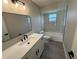 Stylish bathroom featuring modern vanity, new lighting, and tile in shower at 838 Haulover Dr, Altamonte Springs, FL 32714