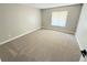 Bright bedroom with neutral carpet, fresh paint, and a window at 838 Haulover Dr, Altamonte Springs, FL 32714