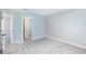 An airy bedroom featuring carpeted floors, light-colored walls, and a door leading to a bathroom at 838 Haulover Dr, Altamonte Springs, FL 32714