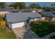 Charming single-Gathering home featuring a grey roof, stone accents, and well-manicured lawn at 838 Haulover Dr, Altamonte Springs, FL 32714