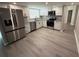 Modern kitchen featuring white cabinets, stainless steel appliances, and stylish flooring at 838 Haulover Dr, Altamonte Springs, FL 32714