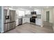 Modern kitchen featuring stainless steel appliances, white cabinets, granite countertops, and grey flooring at 838 Haulover Dr, Altamonte Springs, FL 32714