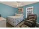 Bedroom with a queen size bed and an arm chair at 106 Turtle Run, Umatilla, FL 32784