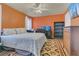 Comfortable bedroom featuring a queen size bed, home office desk, and a dresser at 106 Turtle Run, Umatilla, FL 32784