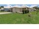 Well-manicured yard with a home featuring a metal roof and mature landscaping at 106 Turtle Run, Umatilla, FL 32784