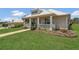 A quaint home with well-kept lawn and landscaping, as well as a covered porch ideal for relaxing and enjoying the outdoors at 106 Turtle Run, Umatilla, FL 32784