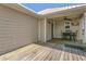 Covered porch with a ceiling fan, seating, and a private entrance at 106 Turtle Run, Umatilla, FL 32784