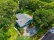 Aerial view of a blue home featuring a new roof, driveway, and manicured lawn at 1202 Marshall Ct, Eustis, FL 32726