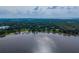 Breathtaking aerial view of a lake community with lush trees, lakefront homes, and a peaceful atmosphere at 1202 Marshall Ct, Eustis, FL 32726