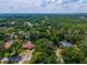 Expansive aerial view of a residential neighborhood with lush greenery and clear blue skies at 1202 Marshall Ct, Eustis, FL 32726