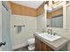 Cozy bathroom showcasing wainscoting, a wood vanity, and a shower with a curtain at 1202 Marshall Ct, Eustis, FL 32726