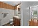 Bathroom with bamboo accent wall and wood-look flooring with updated lighting at 1202 Marshall Ct, Eustis, FL 32726