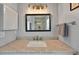 Modern bathroom vanity featuring marble countertops, a decorative mirror, and vintage-inspired lighting at 1202 Marshall Ct, Eustis, FL 32726