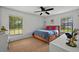 Sunny bedroom with large windows and natural light, complemented by neutral-toned carpet at 1202 Marshall Ct, Eustis, FL 32726