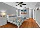 Bedroom featuring hardwood floors, contemporary decor, and ample natural light, creating a relaxing atmosphere at 1202 Marshall Ct, Eustis, FL 32726