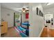 Bedroom with colorful rug, bright walls, ceiling fan, and hallway view at 1202 Marshall Ct, Eustis, FL 32726