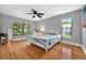 Bright bedroom with hardwood floors, a large window, and neutral paint at 1202 Marshall Ct, Eustis, FL 32726