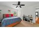 Comfortable bedroom with large window, built-in shelving, and neutral carpet at 1202 Marshall Ct, Eustis, FL 32726