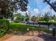 Gated community boat storage area with several boats, manicured lawns, and lush trees at 1202 Marshall Ct, Eustis, FL 32726