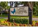 Decorative community sign for Lake Joanna Estates surrounded by colorful flowers and greenery at 1202 Marshall Ct, Eustis, FL 32726