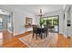 Dining area with stylish chandelier, piano and sliding door access to the patio at 1202 Marshall Ct, Eustis, FL 32726