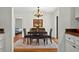 Elegant dining room with hardwood floors, a chandelier, and a glimpse into an adjacent bedroom at 1202 Marshall Ct, Eustis, FL 32726