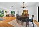 Bright dining room featuring hardwood floors, a wooden dining table, and easy access to the living areas at 1202 Marshall Ct, Eustis, FL 32726