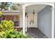 Inviting front porch featuring slate flooring, a hanging lantern and lush landscaping at 1202 Marshall Ct, Eustis, FL 32726
